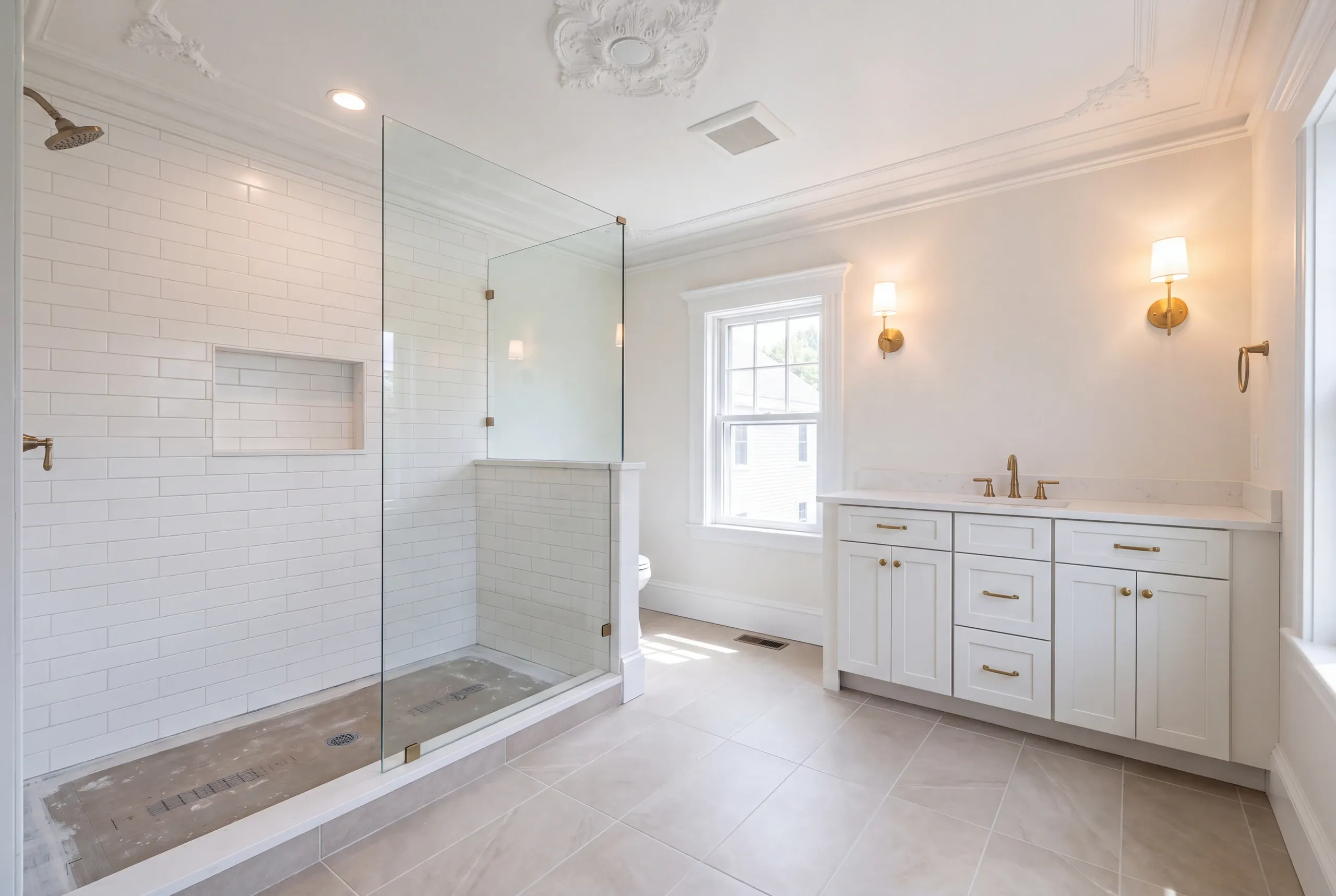 Bathroom remodeling in Bath, ME: white subway tile shower with an untiled mortar floor under an ornate plaster ceiling medallion